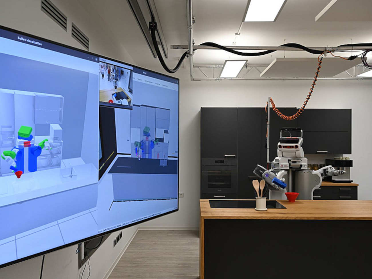 A robot works in a laboratory equipped with a kitchen
