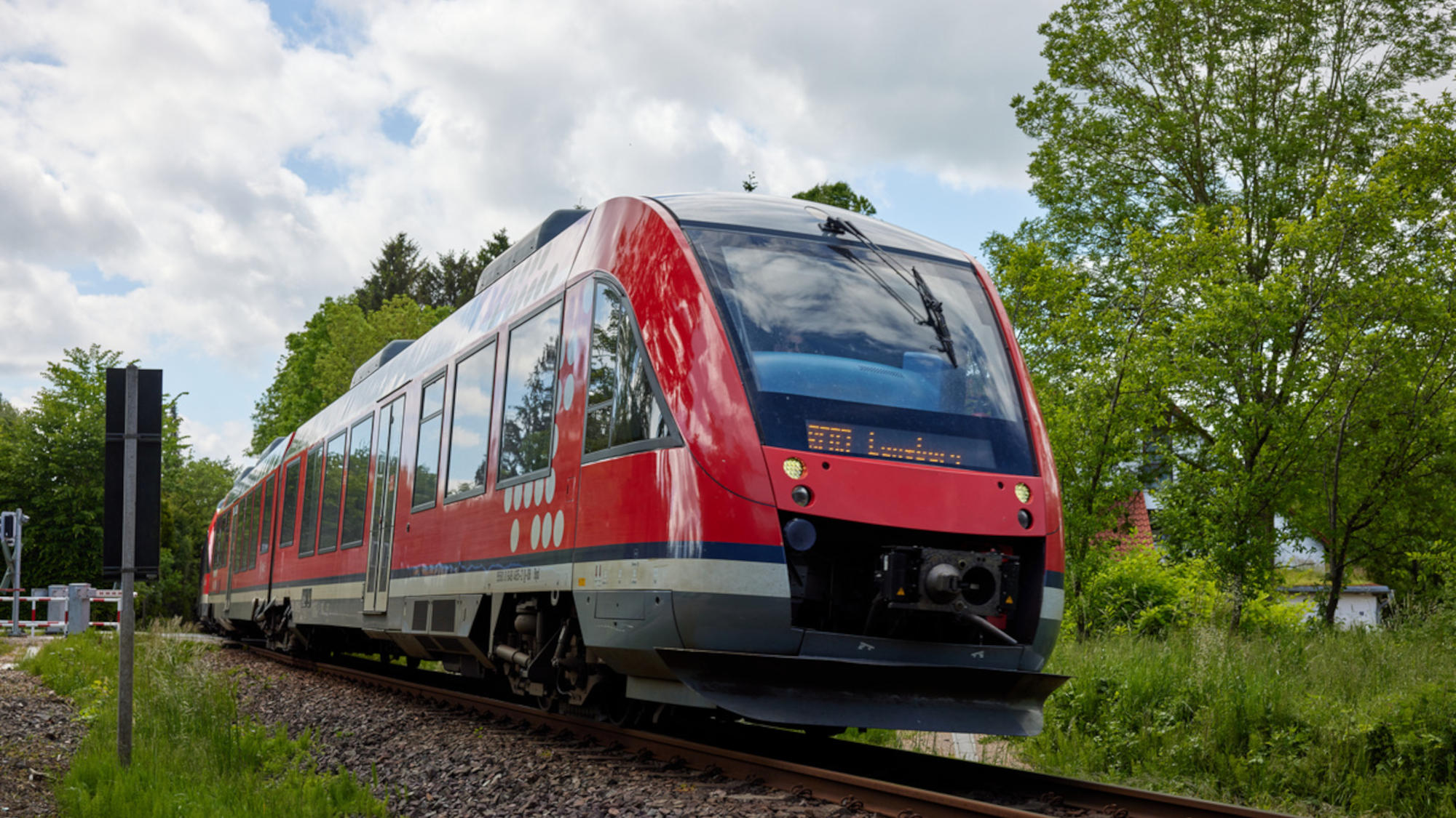 Side view of a regional train on rails.