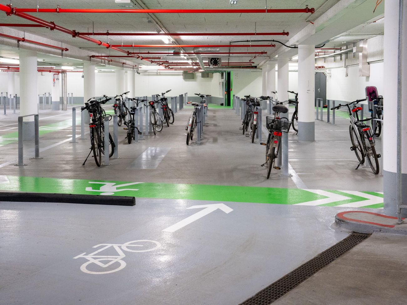 Locked bicycles are stored in a bicycle parking garage.