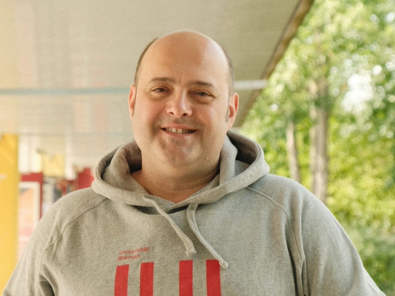 A man is smiling at the camera.