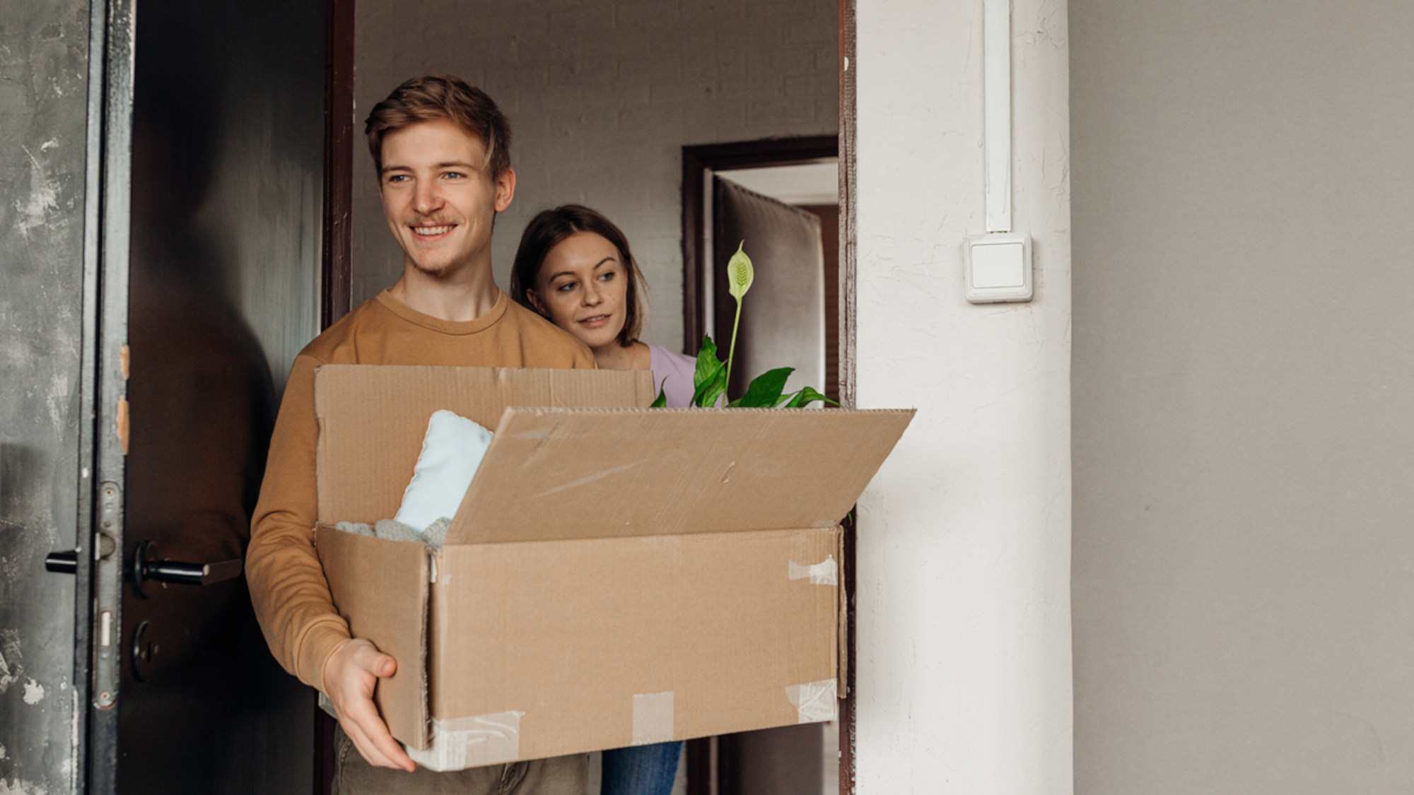 Two people with a moving box