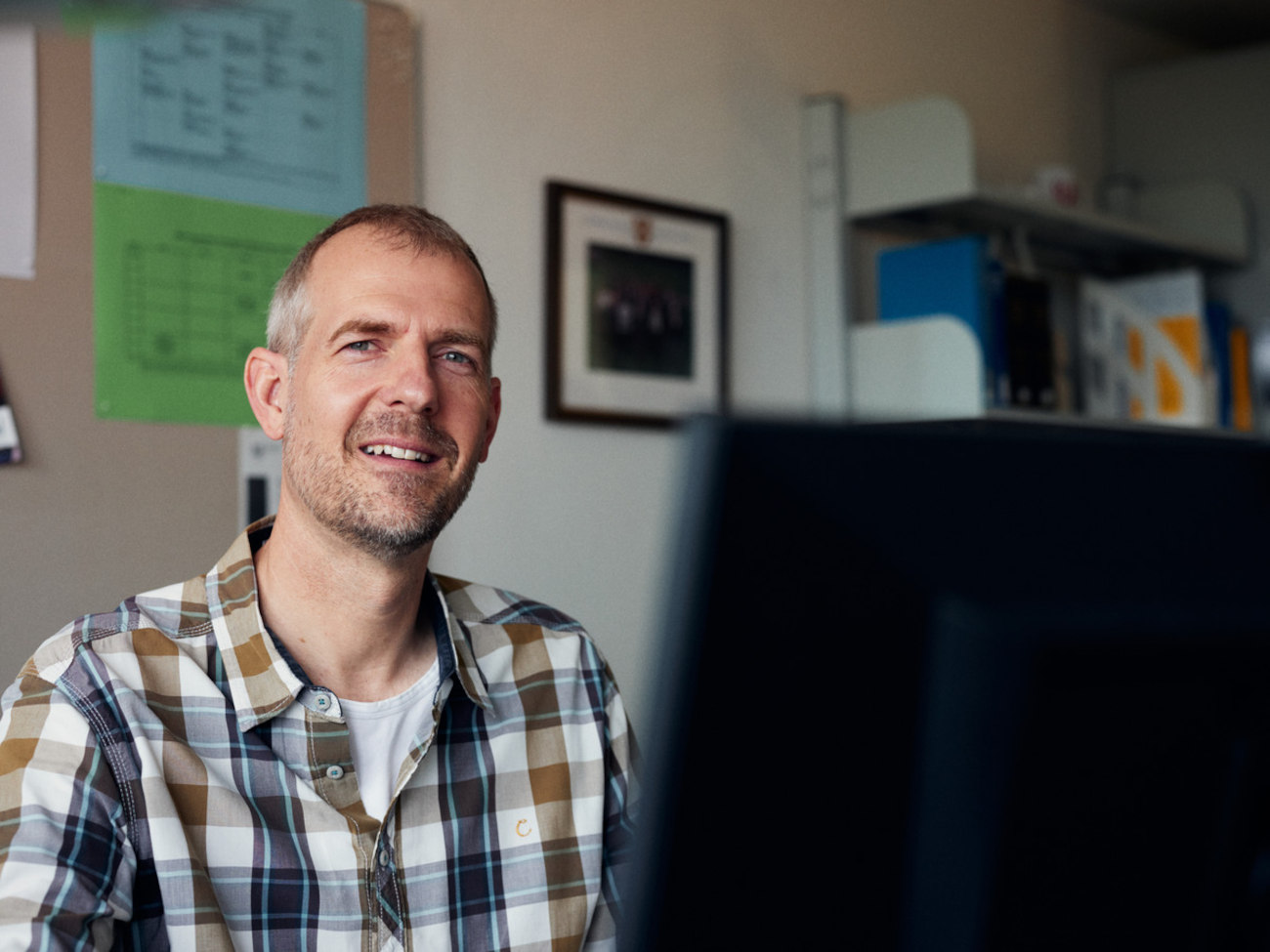 Norman Sieroka sits at his laptop in an office.