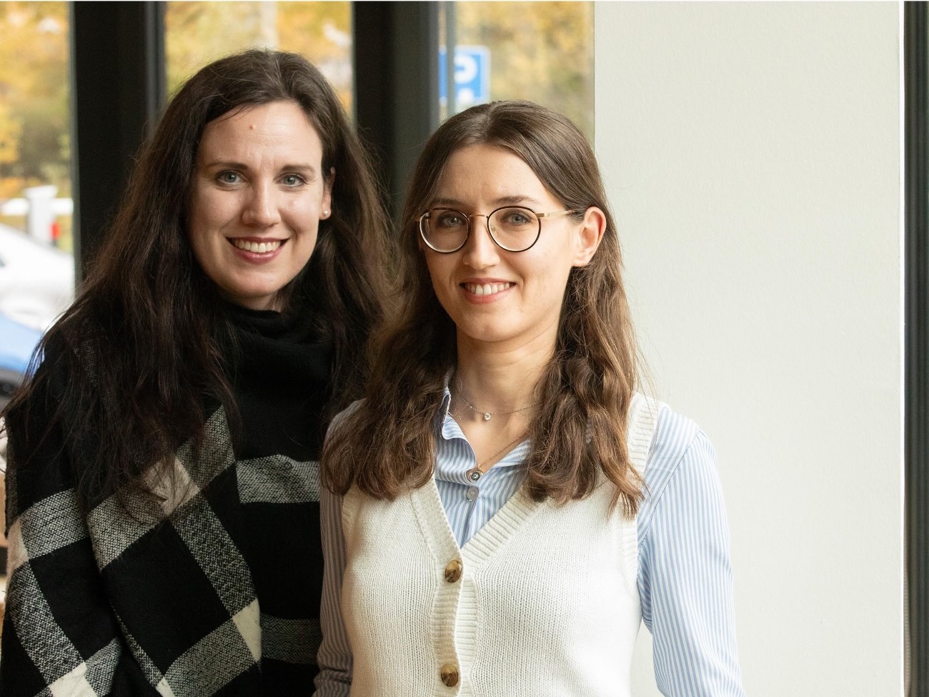 Portrait photo of two researchers standing next to each other. 