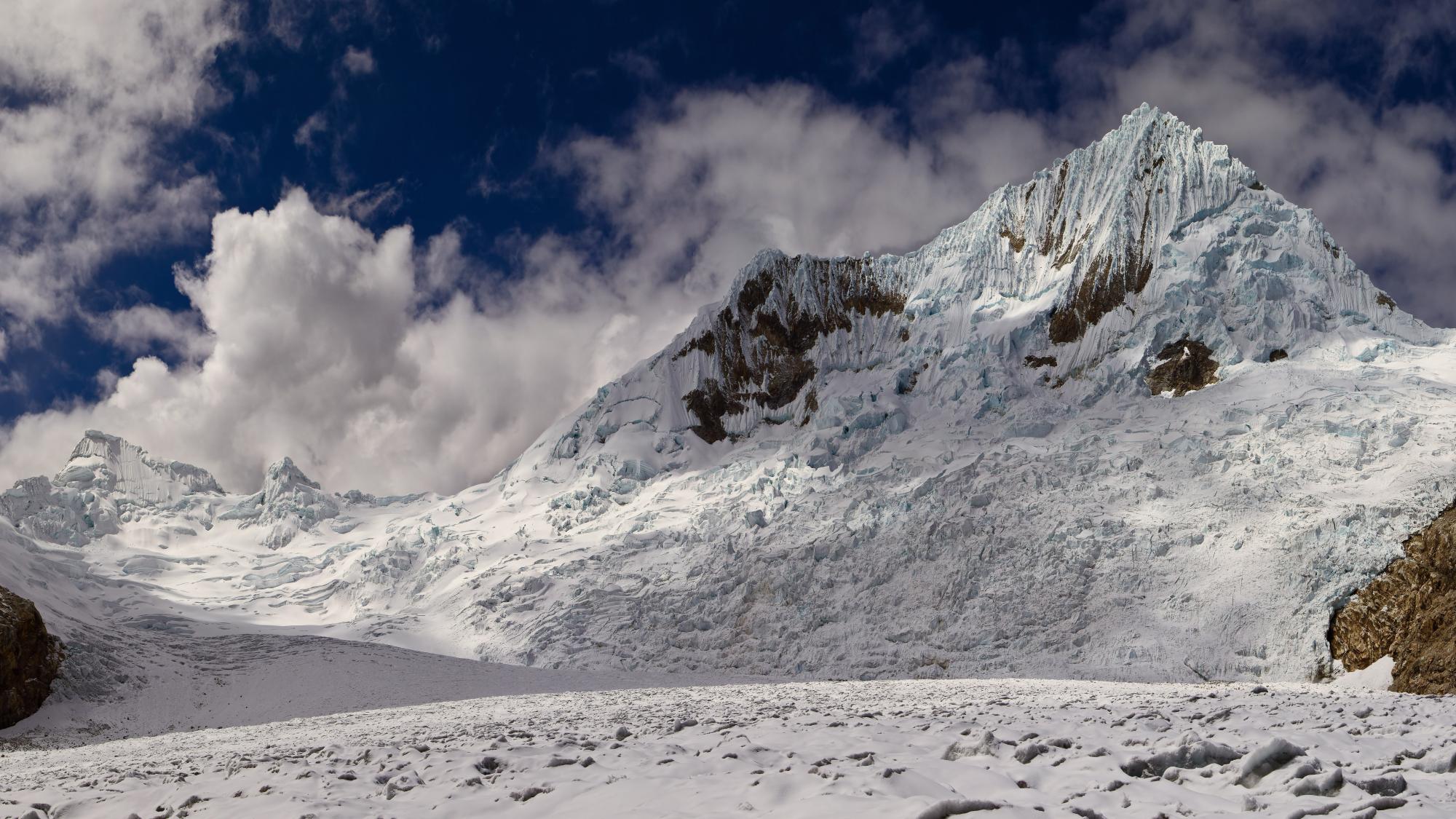 A glacier in front of a cloudy sky.