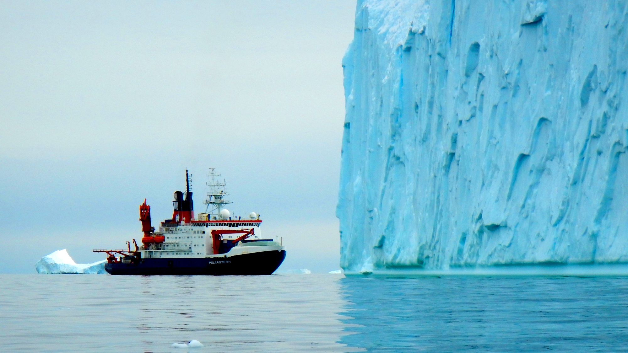 A ship passes an iceberg. 