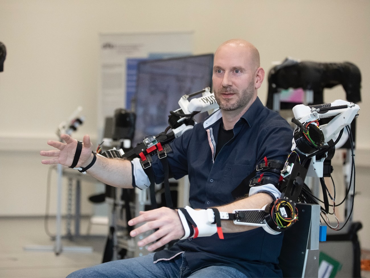 Mark Tabie is sitting in a mechanical exoskeleton. 