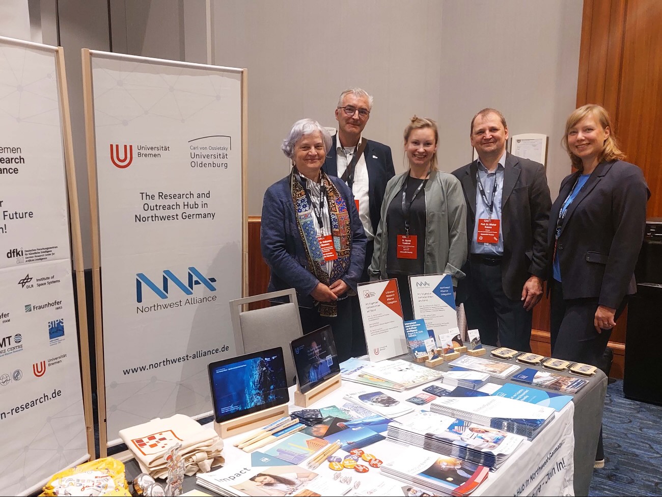 Five people are standing at the UBRA booth at the GAIN25 conference in Boston, USA.