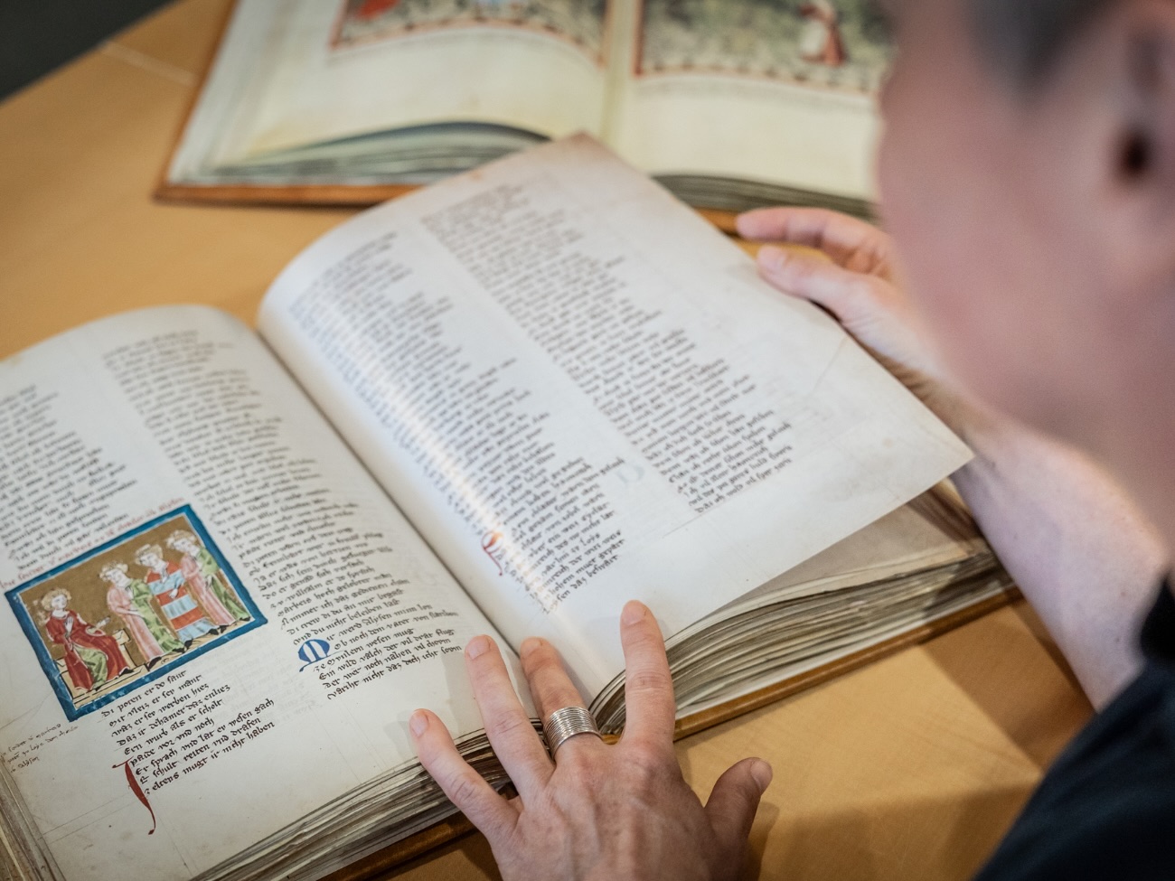 Barbara Aehnlich is flipping through an old book. 