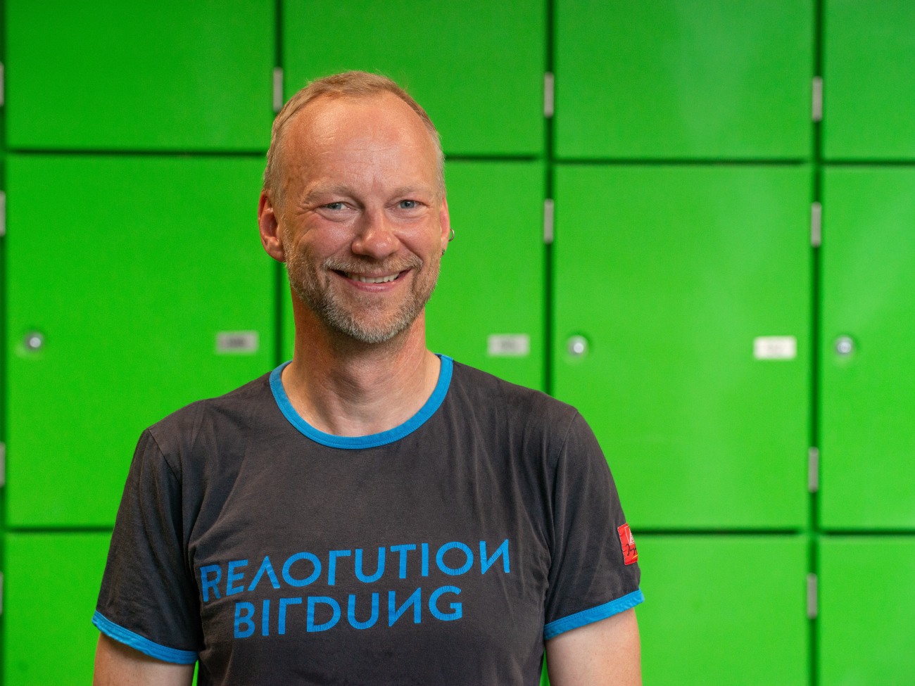 A man smiles at the camera.