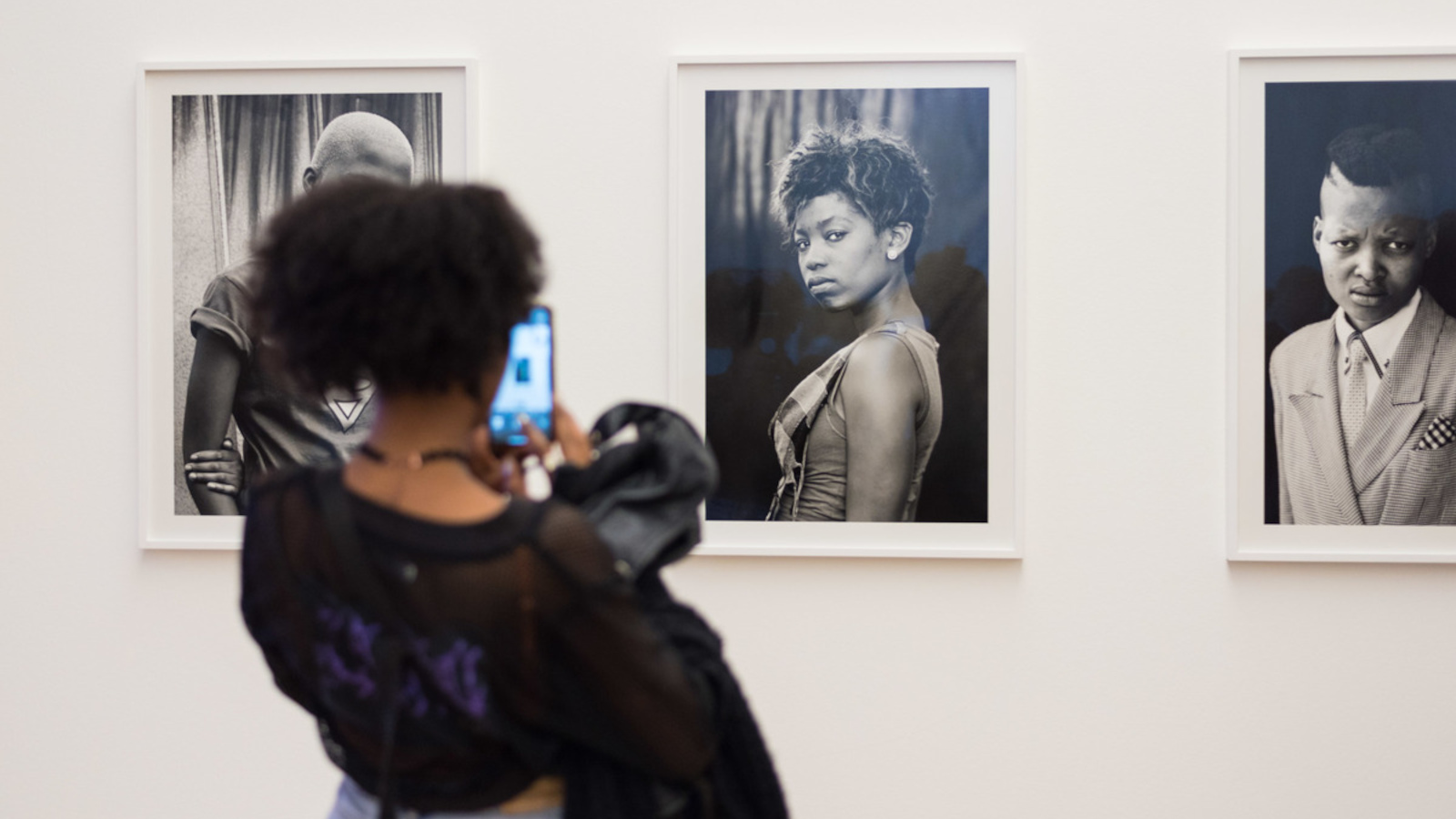 The picture shows a woman looking at a work of art at the “Youth vs. Crisis: A Generation in Search of a Future” exhibition. 