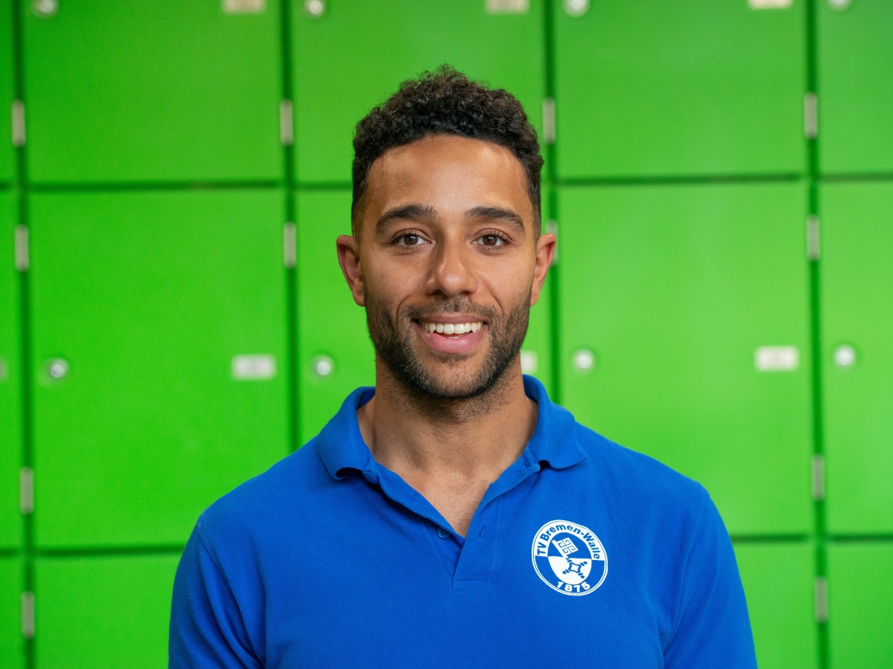 A man smiles at the camera.