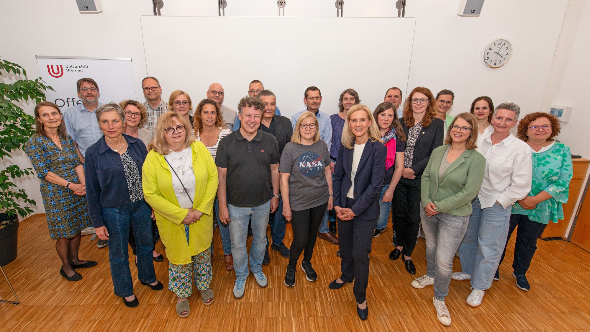 A group of people are smiling at the camera.