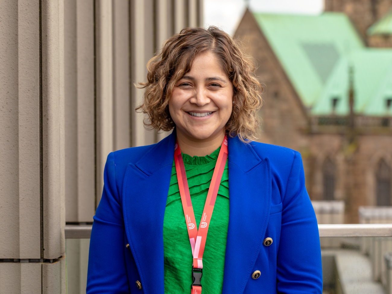 A woman smiles at the camera. 