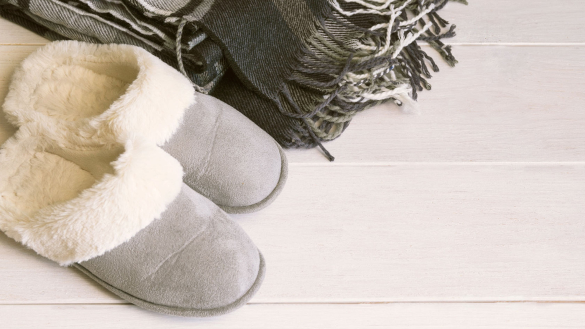 Gray cozy slippers with fur trim.